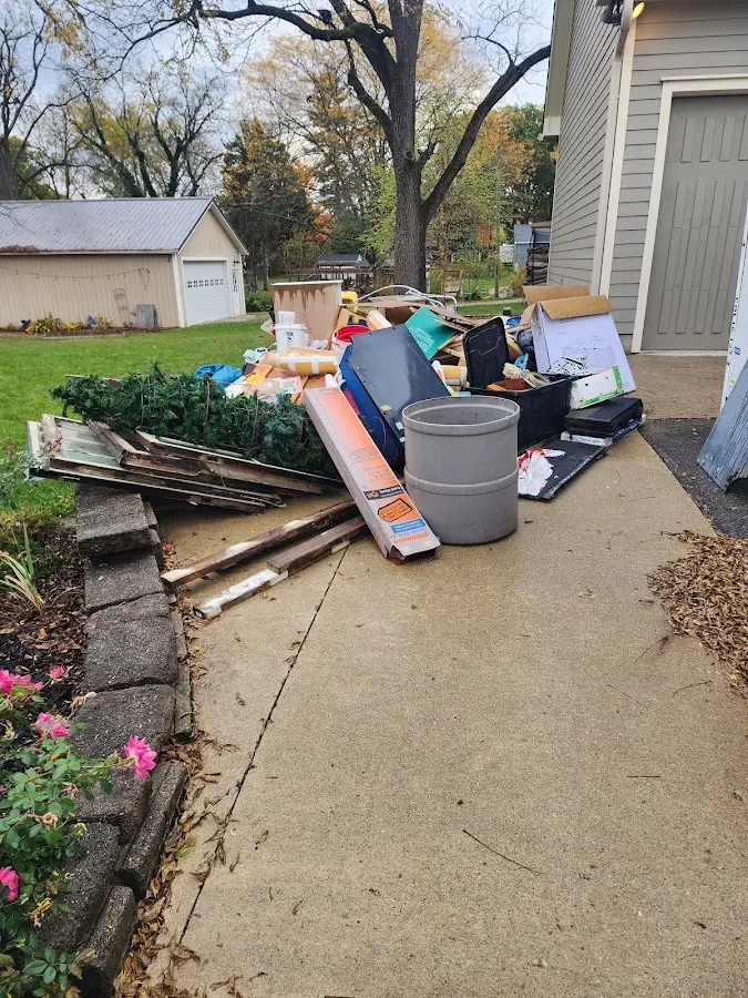 Dumpster being loaded with debris for 10 Yard Dumpster Rental in Elmendorf